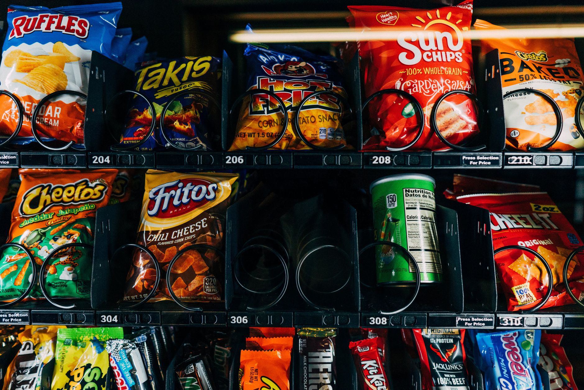 A close-up view of a vending machine filled with an assortment of tasty chips.